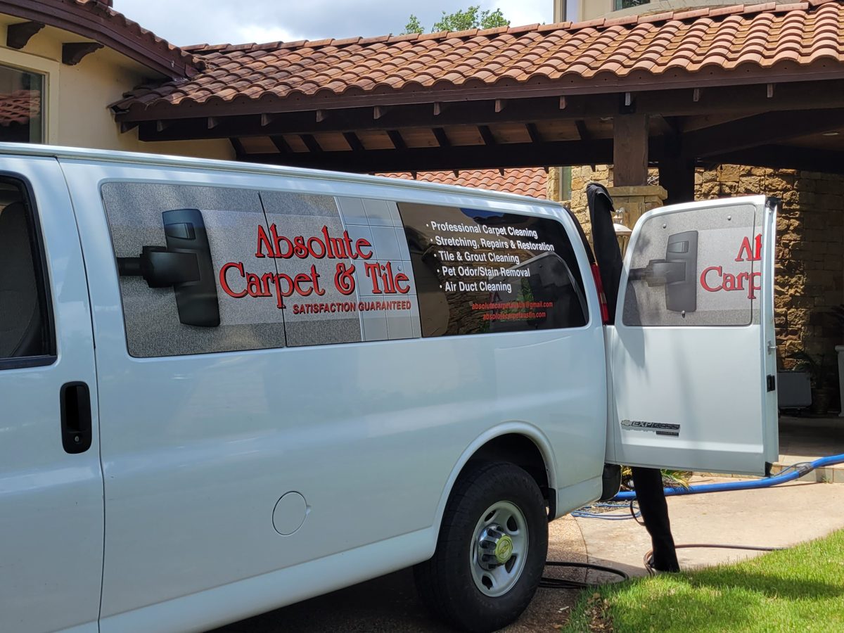 Absolute Carpet & Tile service van parked at an Austin home during a carpet cleaning job